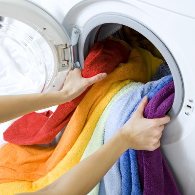 woman taking color  clothes from washing machine
